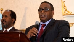 FILE - Somalia’s parliament has endorsed the new cabinet of Prime Minister Omar Abdirashid Ali Sharmarke, right. He’s shown addressing delegates after being nominated for his post by President Hassan Sheikh Mohamud, left, in Mogadishu, Dec. 17, 2014.