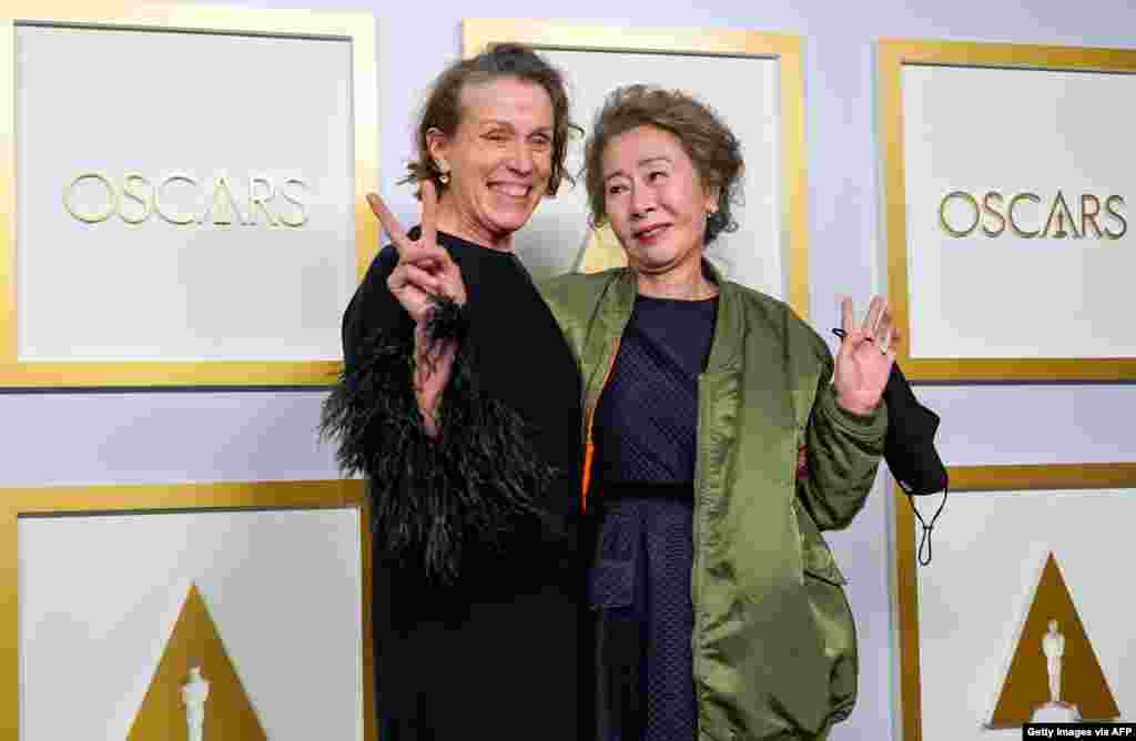 Frances McDormand, left, winner of Best Actress in a Leading Role for &#39;Nomadland,&#39; and Yuh-Jung Youn, winner of Best Actress in a Supporting Role for &#39;Minari,&#39; pose in the press room at the Oscars on April 25, 2021.