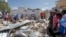 Somalis search for bodies amidst wreckage at the scene of a blast outside the compound of a district headquarters in the capital Mogadishu, Somalia, Sept. 2, 2018. 