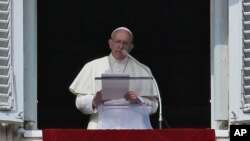 FILE - Pope Francis speaks his studio window overlooking St. Peter's Square at the Vatican, Feb. 21, 2016.