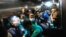 Police escort four of the eight suspected Islamist militants accused of the slayings of two men including a prominent gay rights activist five years ago, in an elevator as they head towards a court in Dhaka, Bangladesh, Aug. 31, 2021. 