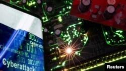 (FILE) A smartphone with a displayed Russian flag with the word "Cyberattack" and binary codes over it is placed on a computer motherboard in this illustration taken February 23, 2023.