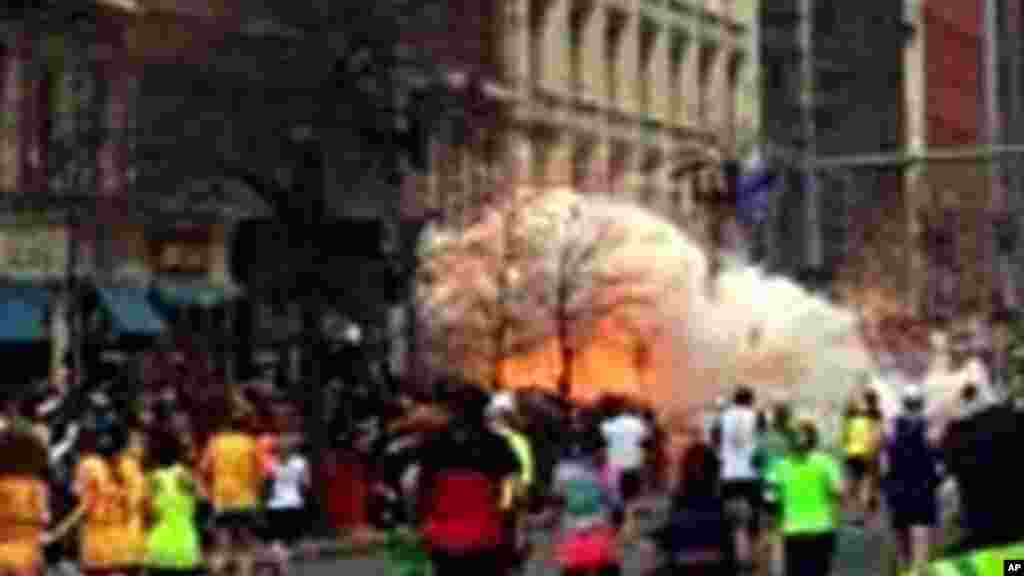 In this image from video provided by WBZ TV, spectators and runners run from what was described as twin explosions that shook the finish line of the Boston Marathon, April 15, 2013. 