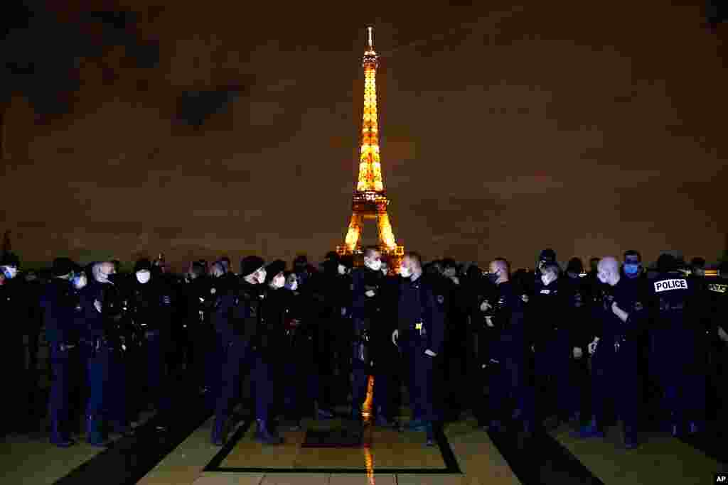 French police officers gather on the Trocadero square in front of the Eiffel Tower to protest against their working conditions, in Paris.