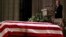 =Former President George W. Bush speaks in front of the flag-draped casket of his father, former President George H.W. Bush, at the State Funeral at the National Cathedral, Dec. 5, 2018, in Washington. 