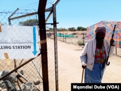 A woman leaves a polling station in Thamaga, Botswana, after casting her vote on Oct. 30, 2024.