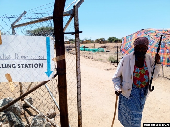 A woman leaves a polling station in Thamaga, Botswana, after casting her vote on Oct. 30, 2024.