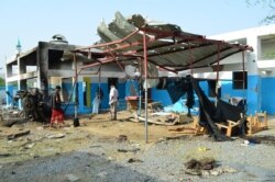 FILE - Yemeni workers clean a hospital operated by Doctors Without Borders (MSF) in Abs, in the rebel-held northern province of Hajja, after the hospital was allegedly hit by an airstrike by the Saudi-led coalition, Aug. 16, 2016.