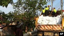 Thai Flood Volunteers Unload Sandbags in Front of Flooded Temple at North Edge of Bangkok