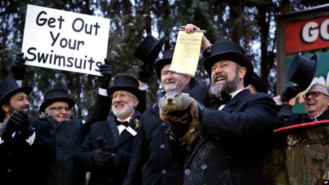 Groundhog Club co-handler Al Dereume, second from right, holds Punxsutawney Phil, the weather prognosticating groundhog, during the 133rd celebration of Groundhog Day on Gobbler's Knob in Punxsutawney, Pa. Saturday, Feb. 2, 2019.