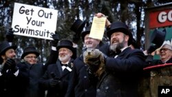 Groundhog Club co-handler Al Dereume, second from right, holds Punxsutawney Phil, the weather prognosticating groundhog, during the 133rd celebration of Groundhog Day on Gobbler's Knob in Punxsutawney, Pa. Saturday, Feb. 2, 2019.