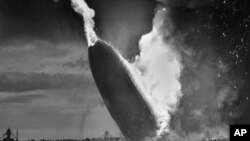 FILE - In this May 6, 1937 file photo, the German dirigible Hindenburg crashes to earth in flames after exploding at the U.S. Naval Station in Lakehurst, N.J. Only one person is left of the 62 passengers and crew who survived when the Hindenburg burst into flames 80 years ago Saturday, May 6, 2017.