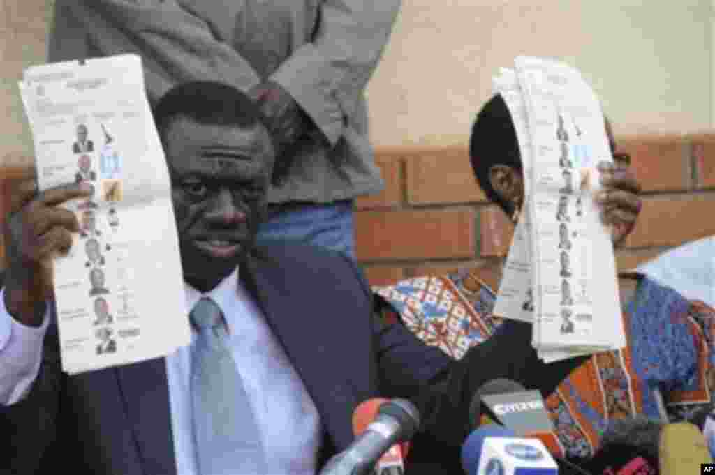 Forum for Democratic Change opposition leader Dr. Kizza Besigye displays pre-marked ballot papers, during a news conference at party headquarters in Kampala Uganda, February 19, 2011