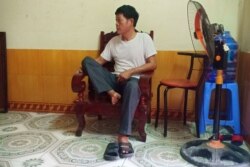 Pham Van Thin, father of 26-year-old Pham Thi Tra My, who is feared to be among the 39 people found dead in a truck in Britain, sits inside his house in Vietnam's Ha Tinh province, Oct. 26, 2019.