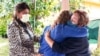 Elvira Carvajal, right, hugs Blanca Flores as Irma Durand cries after watching Joe Biden become U.S. president, Jan. 20, 2021, in Homestead, Fla. Immigrants cheered Biden's plan to provide millions without legal U.S. status a path to citizenship.