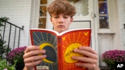 Chris Stanislawski, 14, of Garden City, N.Y., didn't finish any books in his 8th grade English class, in part because their google classroom had detailed summaries of each chapter of every book. (AP Photo/Brittainy Newman)