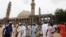 Nigerian Muslims walk past an uncompleted mosque in Maiduguri, Nigeria. Suspected Islamic militants wearing army fatigues gunned down 44 people praying at a mosque in northeast Nigeria, August 8, 2013.