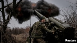 (FILE) A serviceman of the Ukrainian Armed Forces fires a self-propelled howitzer towards Russian troops at a front line near the town of Chasiv Yar in Donetsk region, Ukraine November 18, 2024.