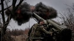 FILE PHOTO: Ukrainian servicemen fire a self-propelled howitzer towards Russian troops at a front line near the town of Chasiv Yar