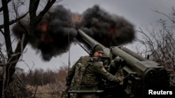 FILE PHOTO: Ukrainian servicemen fire a self-propelled howitzer towards Russian troops at a front line near the town of Chasiv Yar