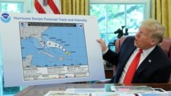 U.S. President Donald Trump holds a projected track of Hurricane Dorian map that appears to have been extended to Florida and parts of Alabama during a meeting on the hurricane in the Oval Office of the White House in Washington, Sept. 4, 2019.