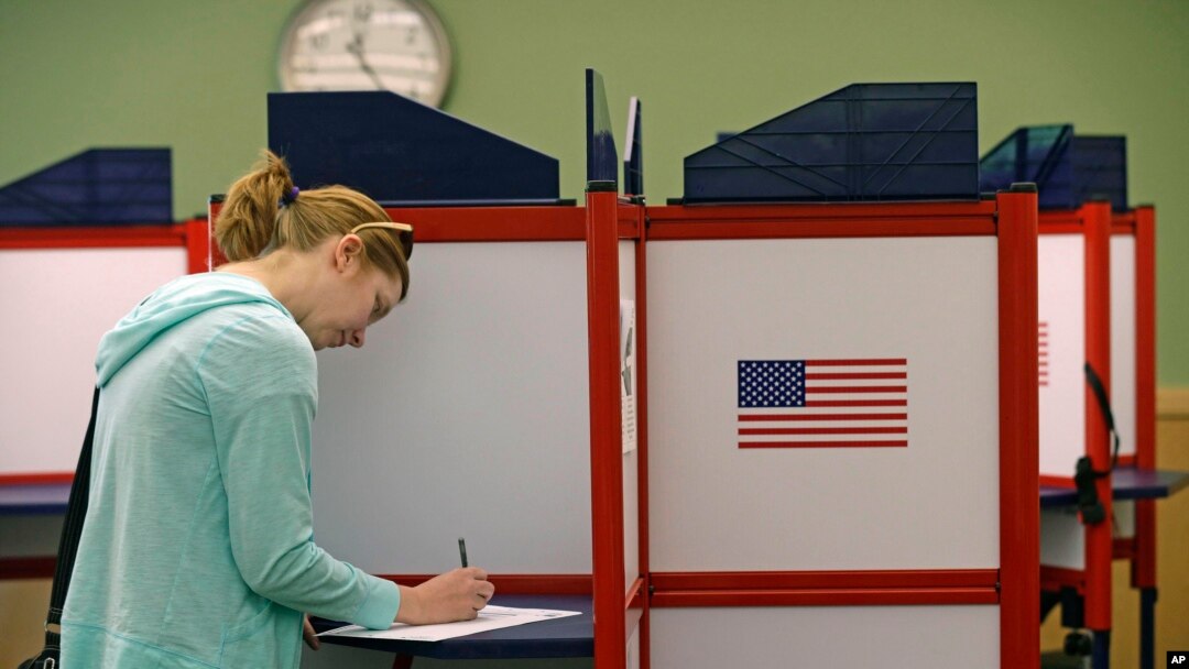 FILE - Kate Irish casts her vote at the Durham County North Regional Library in Durham, N.C., May 8, 2018.