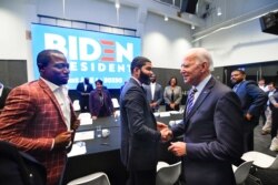 FILE - Democratic presidential candidate former Vice President Joe Biden, right, meets with an assembly of Southern black mayors including Mississippi Mayor Chokwe Lumumba and Virginia Mayor Levar Stoney, left, in Atlanta, Nov. 21, 2019.