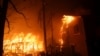 Thousands flee, homes destroyed as Los Angeles wildfires burn out of control