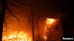 Flames rise from buildings as the Eaton Fire burns in Pasadena, California, Jan. 7, 2025.