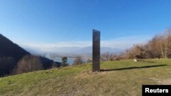 A metal monolith stands on the hills of Batca Doamnei, near Piatra Neamt, Romania, Nov. 27, 2020.