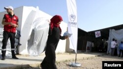 Seorang pengungsi Suriah menerima bantuan dari UNHCR di Tripoli, Lebanon utara, 18 November 2015. (Foto: dok.)