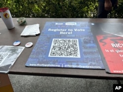 A QR code sign is displayed at Florida Atlantic University on April 11, 2024, in Boca Raton for students to register to vote.
