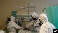 Health care workers transport a COVID-19 patient from an intensive care unit (ICU) at hospital in Kyjov, Brno, Czech Republic, where Coronavirus infections are on a steep rise, setting a new record high for the second straight day, Oct. 22, 2020.