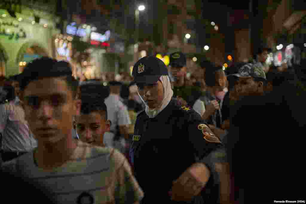 Policewomen work at movie theaters to organize crowds and protect girls from possible sexual harassment in downtown Cairo, June 15, 2018.