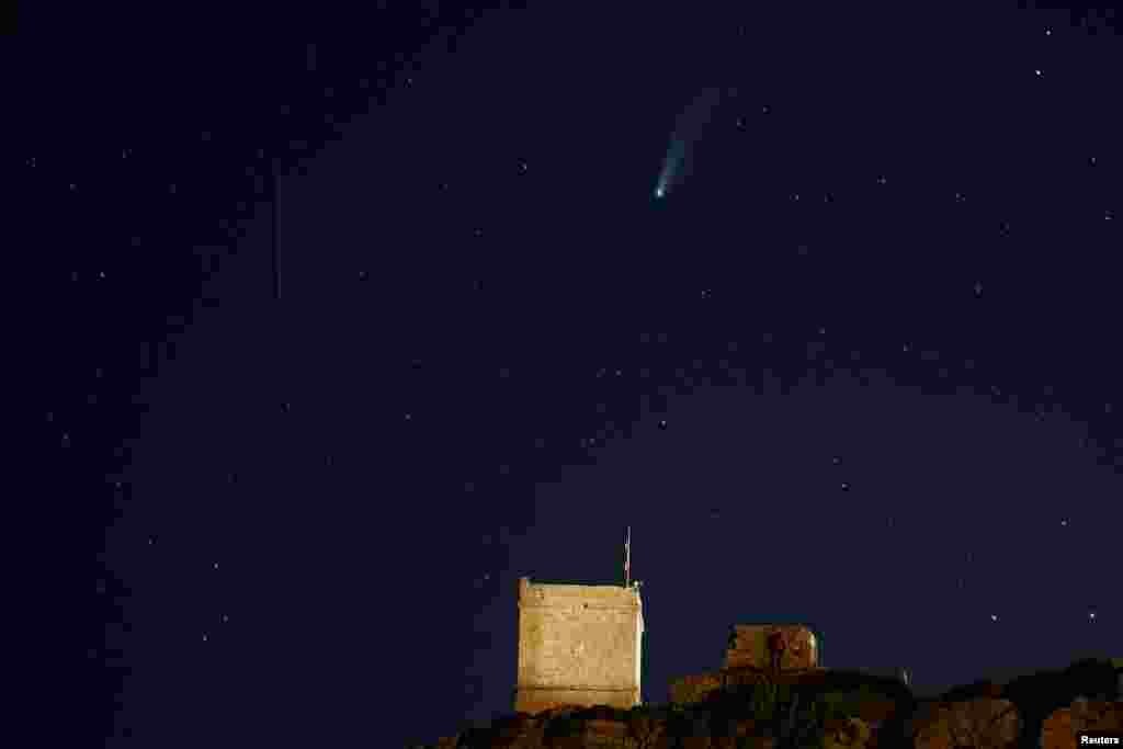 The Comet C/2020 or &quot;Neowise&quot; and a meteor are seen behind Ghajn Tuffieha Tower, a 17th century coastal fortification, at Ghajn Tuffieha Bay, Malta July 20, 2020.