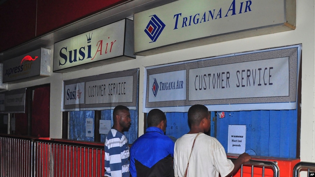 Keluarga penumpang pesawat Trigana Air yang hilang berdiri di depan loket Trigana Air yang tutup di bandara Sentani di Jayapura, Papua, 16 Agustus 2015.