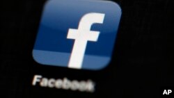 FILE - The Facebook logo is displayed on an iPad in Philadelphia, May 16, 2012.