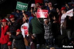 FILE - Supporters react at President Donald Trump's campaign rally in Battle Creek, Mich., Dec. 18, 2019.