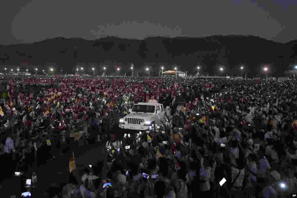 Pope Francis leaves after leading a Holy Mass at Tasitolu park in Dili, East Timor.