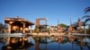 A home destroyed by the Mountain Fire is reflected in water from a swimming pool in Camarillo, California, Nov. 8, 2024. 