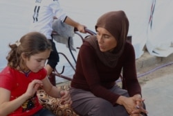 When Basse's daughter Fadya was rescued and returned to her family a few months ago, she initially did not recognize her siblings and parents, pictured in Khanke, Kurdistan region, Iraq, Sept. 28, 2019. (Heather Murdock/VOA)