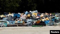 FILE: A pile of trash collected after it washed up on shore from the Pacific Ocean, waiting now to be shipped out, at Papahanaumokuakea Marine National Monument, Midway Atoll, U.S., Taken Sept. 1, 2016.