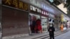 A person walks past a shop closed for business, after the government eased curbs on the COVID-19 control, in Wuhan, China Dec. 10, 2022. 