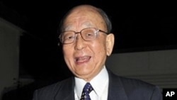 Akira Suzuki, emeritus professor of Hokkaido University, smiles as he leaves his home in Ebetsu for the university in Sapporo in Hokkaido, northern Japan, to hold a press conference, 6 Oct 2010