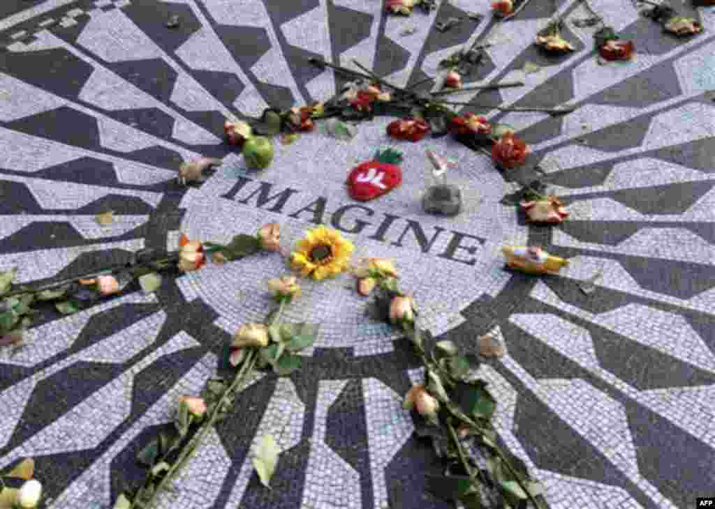 The Imagine mosaic in Strawberry Fields is decorated with flowers and other mementos, Tuesday, Dec. 7, 2010 in New York. Wednesday marks 30 years since John Lennon was murdered outside his New York apartment, triggering a wave of grief around the world. 