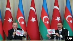 FILE - A picture taken and released on Dec. 10, 2020, by the Turkey shows Turkish President Recep Tayyip Erdogan and Azerbaijani President Ilham Aliyev holding a press conference following their meeting in Baku.