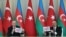 FILE - A picture taken and released on Dec. 10, 2020, by the Turkey shows Turkish President Recep Tayyip Erdogan and Azerbaijani President Ilham Aliyev holding a press conference following their meeting in Baku.