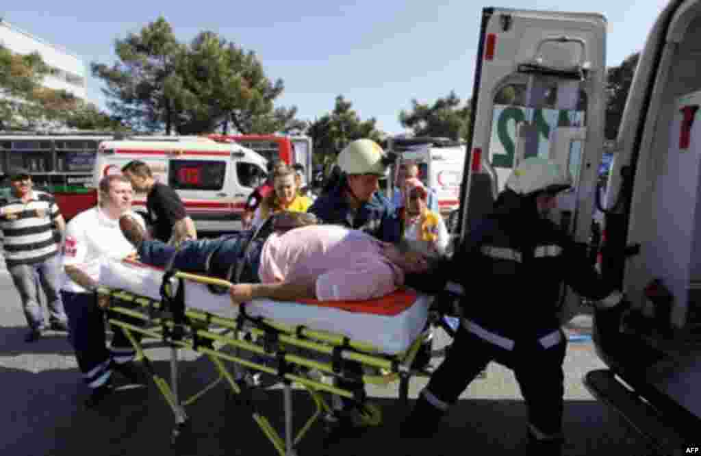 A wounded man is taken to an ambulance following a blast in Istanbul May 26, 2011. A bomb placed on an electric bicycle exploded in Istanbul on Thursday, wounding seven people, Istanbul's police chief Huseyin Capkin told reporters. He said none of the wou