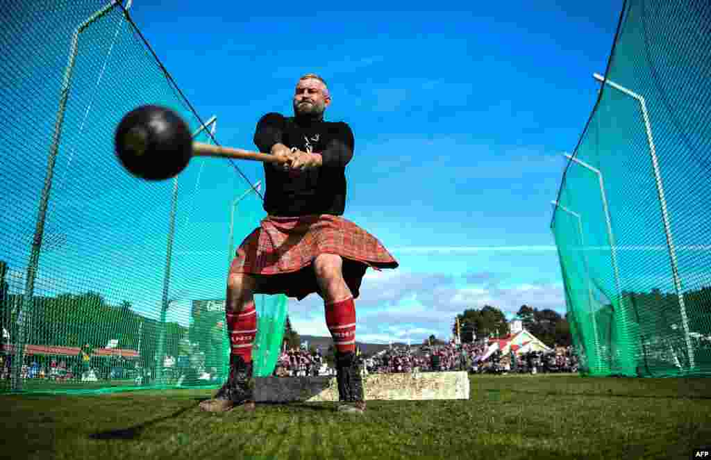 A competitor takes part in the throwing the hammer event during the annual Braemar Gathering in Braemar, central Scotland, Sept. 7, 2019.
