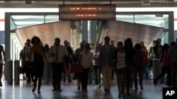 Commuters arrive at Lisbon's Terreiro do Paco ferry station, July 3, 2013. Portugal's financial markets went into a steep nosedive Wednesday as the government teetered on the verge of collapse.